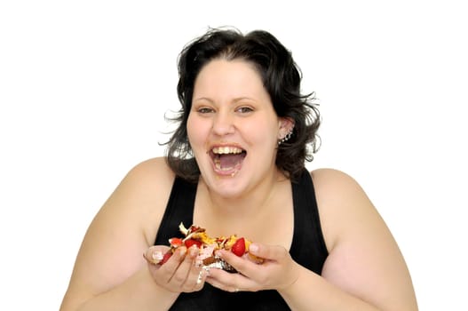 Beautiful large girl laughing with cake remainings in her hand