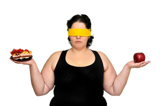 Large girl blindfolded holding a cake and an apple isolated in white