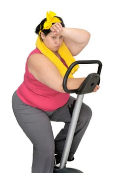 Large girl with fitness bicycle isolated in white