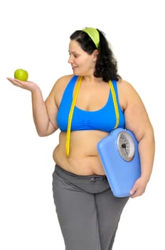 Large girl with apple and weight scale isolated in white