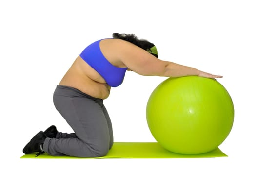 Large girl exercising with big fitness ball isolated in white