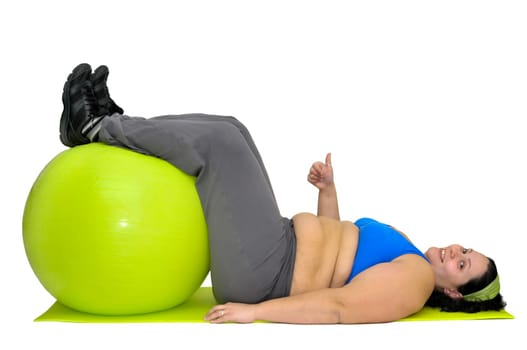Large girl exercising with big fitness ball isolated in white