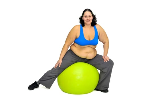 Large girl exercising with big fitness ball isolated in white