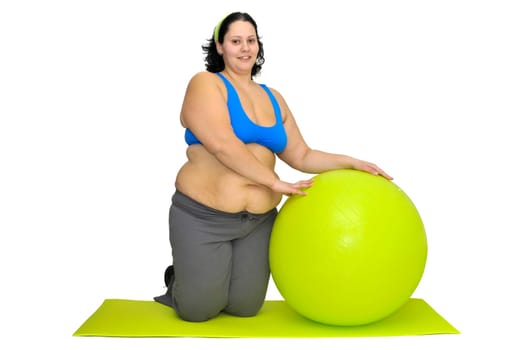 Large girl exercising with big fitness ball isolated in white