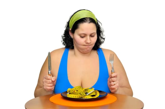 Large girl eating a measuring tape isolated in white