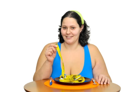 Large girl eating a measuring tape isolated in white