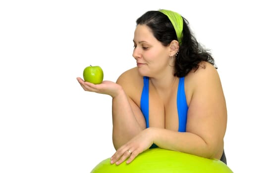 Large girl exercising with big fitness ball isolated in white