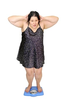 Large girl in nightie holding a scale isolated in white