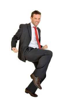 Young businessman jumping isolated in white