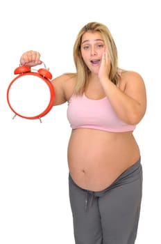 Pregnant woman with alarm clock isolated in white