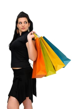 Sexy woman in black dress with colorful bags isolated in white