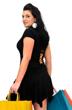 Sexy woman in black dress with colorful bags isolated in white