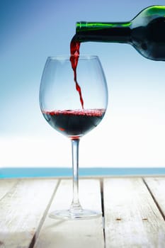 Wine at the beach on a deck in front of the ocean