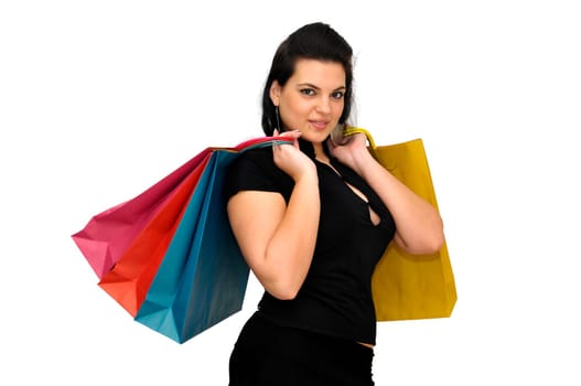 Sexy woman in black dress with colorful bags isolated in white