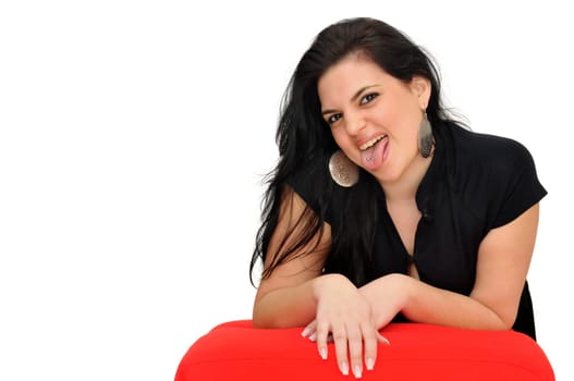 Sexy woman in black dress showing her tongue piercing isolated in white
