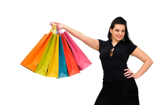 Sexy woman in black dress with colorful bags isolated in white