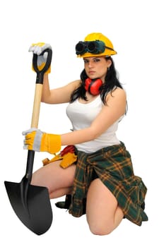 Young sexy construction worker girl with a shovel isolated in white
