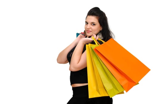 Sexy woman in black dress with colorful bags isolated in white