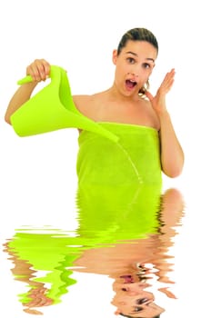 Sexy young girl with towel surprised, filling the image with water isolated in white