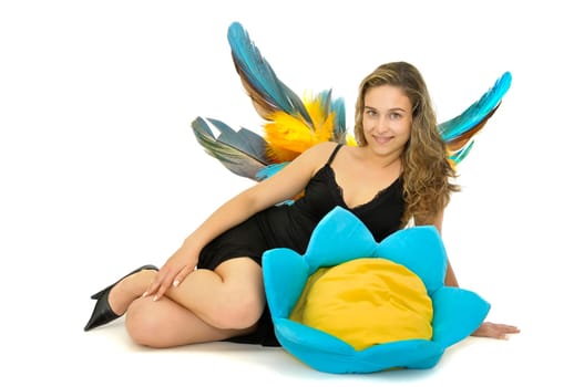 Beautiful young woman with wings posing in a black dress and a flower isolated in white