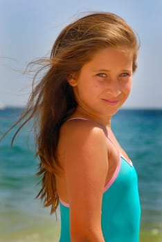 Beautiful young girl posing in the beach