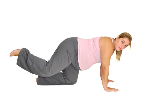 Pregnant woman making exercises isolated in white