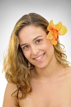 Beautiful young woman portrait with flowers isolated in a light background
