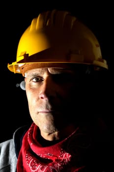 Portrait of a worker isolated in black