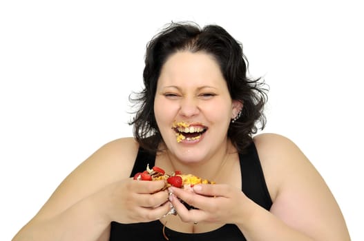 Beautiful large girl laughing with cake remainings in her hand