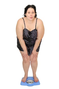 Large girl in nightie holding a scale isolated in white