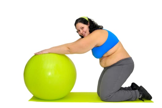 Large girl exercising with big fitness ball isolated in white