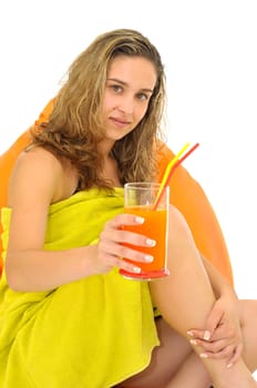 Sexy young girl with a natural juice glass and colorful towel isolated in white