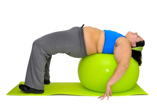 Large girl exercising with big fitness ball isolated in white