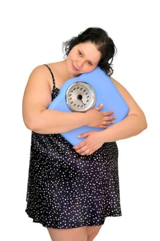 Large girl in nightie holding a scale isolated in white