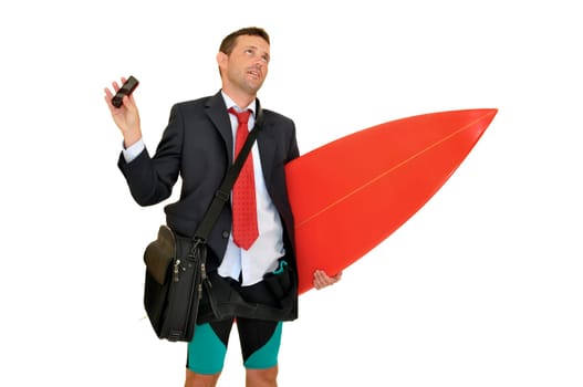 Young businessman with surf board recieving a call from the office