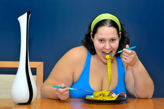 Large girl eating a measuring tape