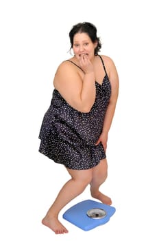 Large girl in nightie holding a scale isolated in white