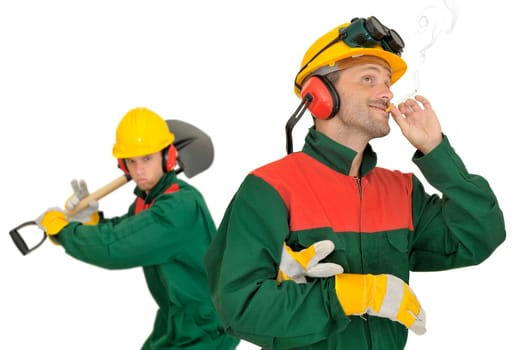 Smoking worker and angry team mate with shovel