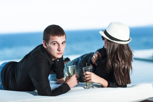 Young couple. Sea on the background