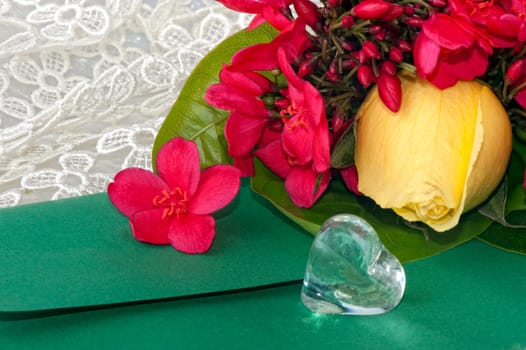 Jar with crystal heart-shaped yellow rose and flowers