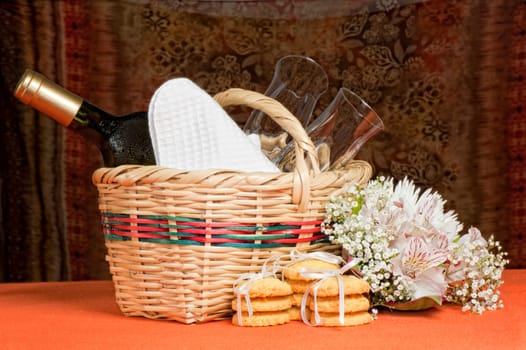 A basket with bottles and glasses Composition