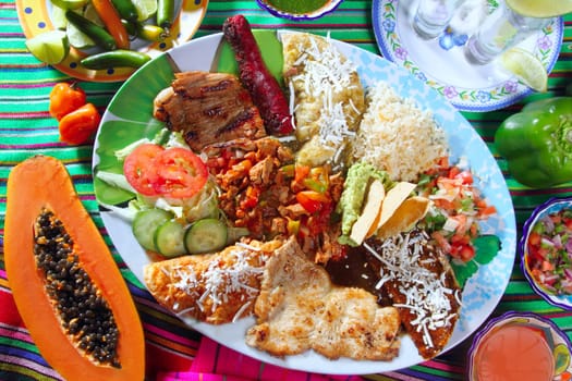Assorted mexican food dish chili sauces papaya tequila