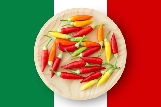 colorful chili peppers plate with Mexico flag in background