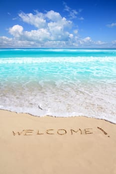 greetings welcome beach spell written on sand Caribbean tropical sea