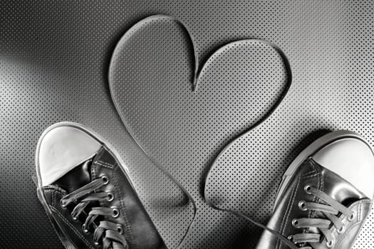 Laces of silver shoes, threads with heart valentines shape