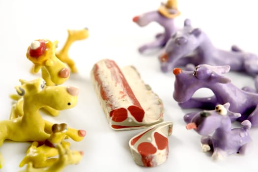Handmade hungry plasticine dogs withy some meat to eat