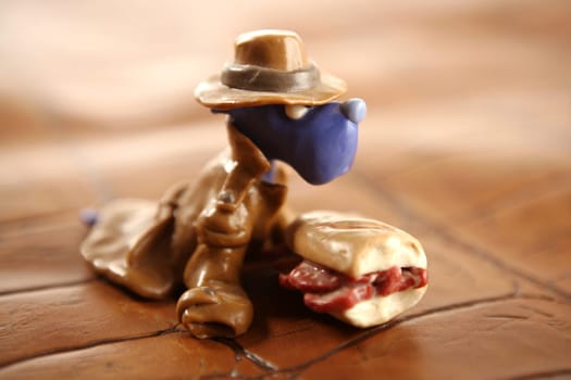 Handmade hungry plasticine dogs withy some meat to eat