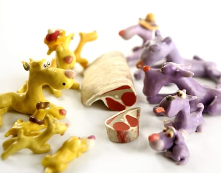 Handmade hungry plasticine dogs withy some meat to eat