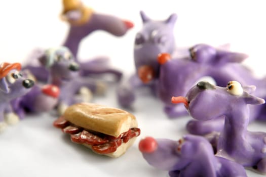Handmade hungry plasticine dogs withy some meat to eat