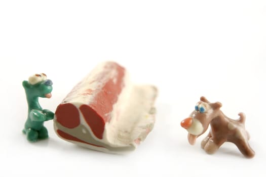 Handmade hungry plasticine dogs withy some meat to eat